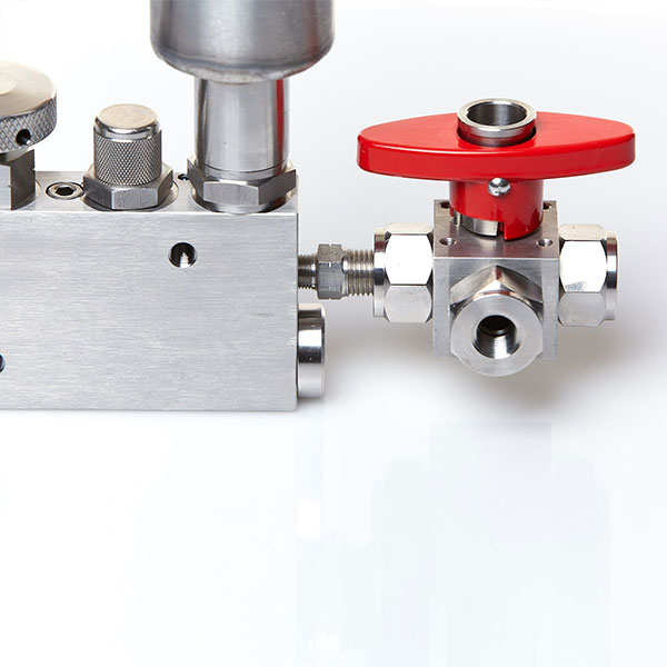 a close up of a directional control valve fitted to a hydraulic hand pump