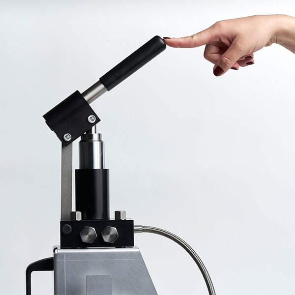 skydrol dispensing pump with a hand holding up the operating handle