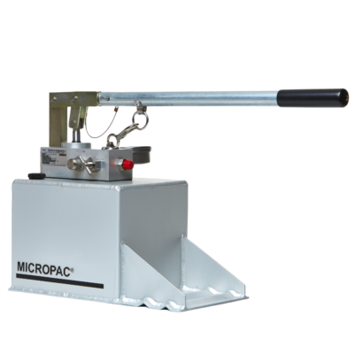 a hydraulic hand pump on top of a fluid reservoir