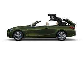 BMW 4 series hood side view of a convertible car with the roof half way between fully open and fully closed