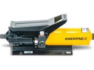 Enerpac PA series Enerpac PA air driven pump, cylindrical yellow reservoir with moulded black air motor section on the end and a treadle type pedal on top.