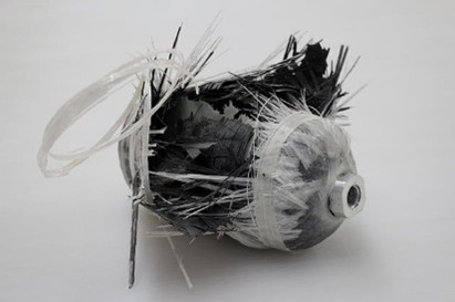 a burst COPV a small pressure vessel made from composite, which has dramatically failed exposing the inner composite weave